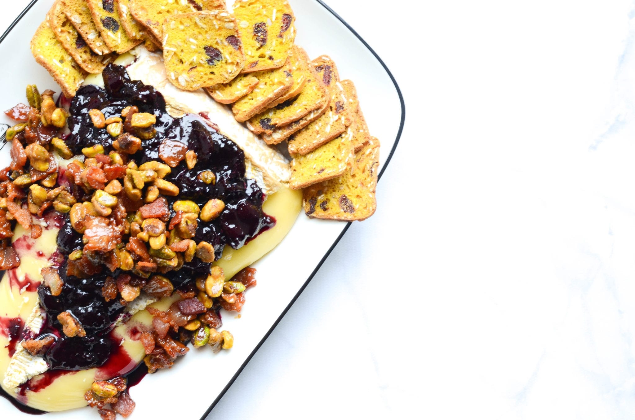 Baked Brie With Red Wine Cherries, Candied Bacon and Pistachios