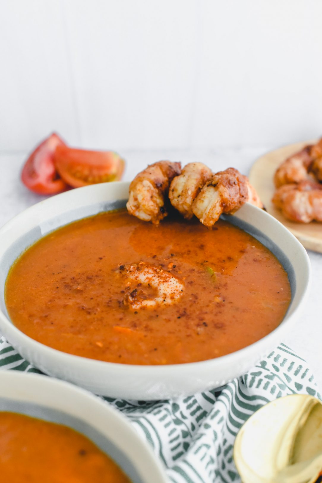 soup in bowl with shrimp on the side