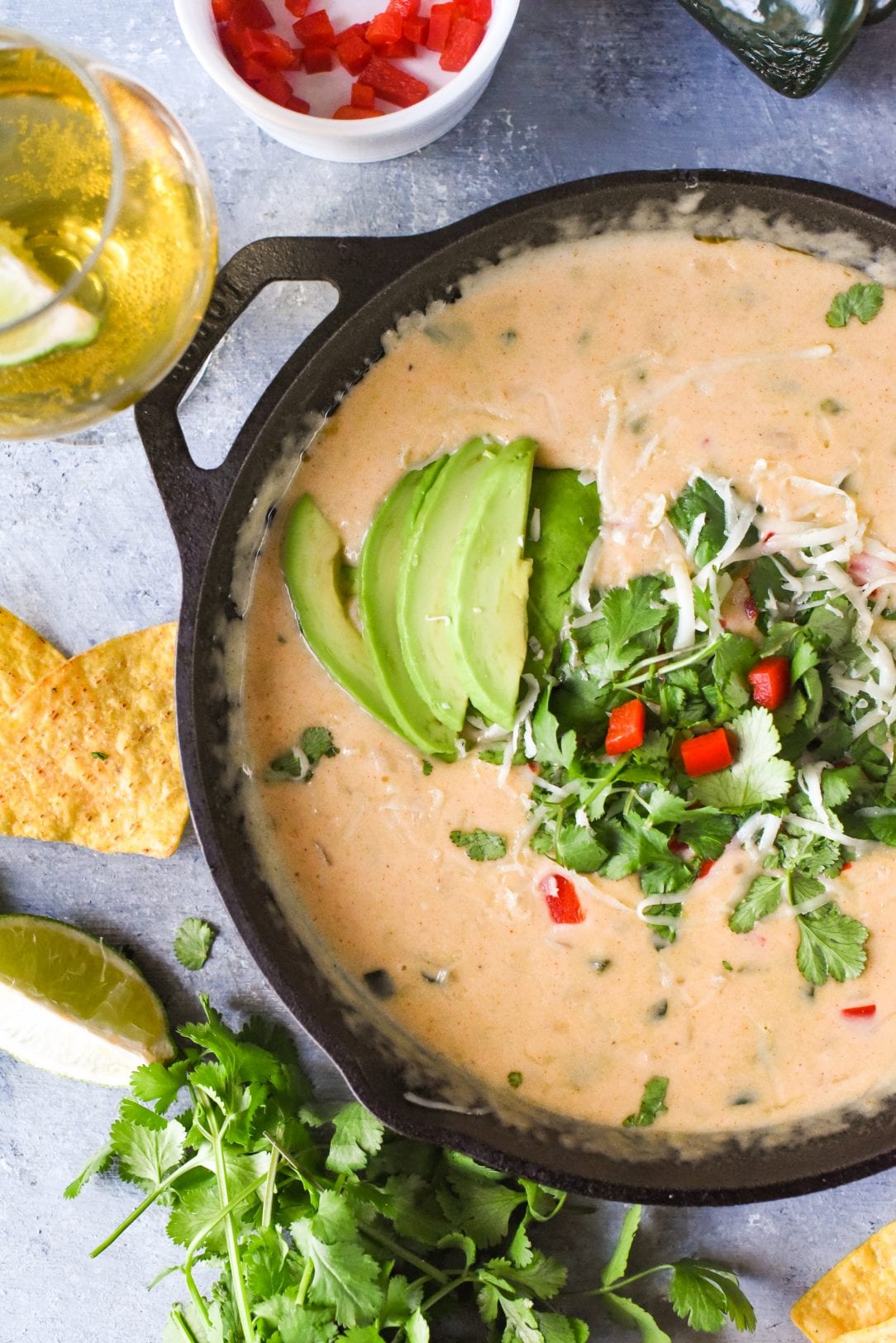 beer cheese queso with avocado slices on top