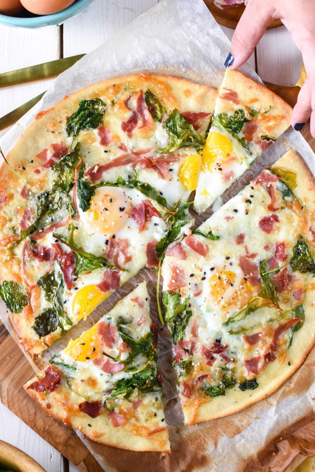 pizza slices with country ham, eggs, spinach and seasoning