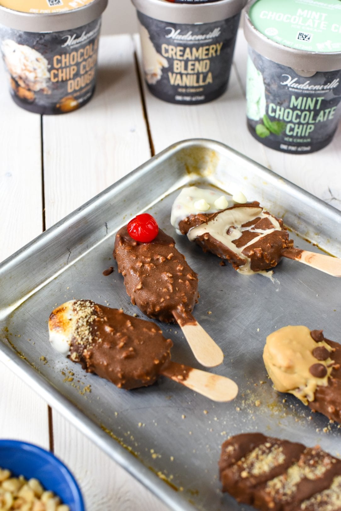 chocolate covered ice cream bars on a baking sheet
