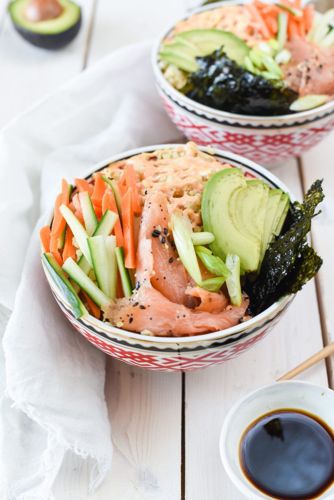 Whole30 Smoked Salmon Sushi Bowl on a table with a small bowl of soy sauce