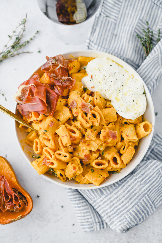 pasta with cheese and prosciutto in a bowl