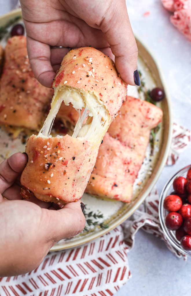 Cheese pull of a cranberry coated turkey roll