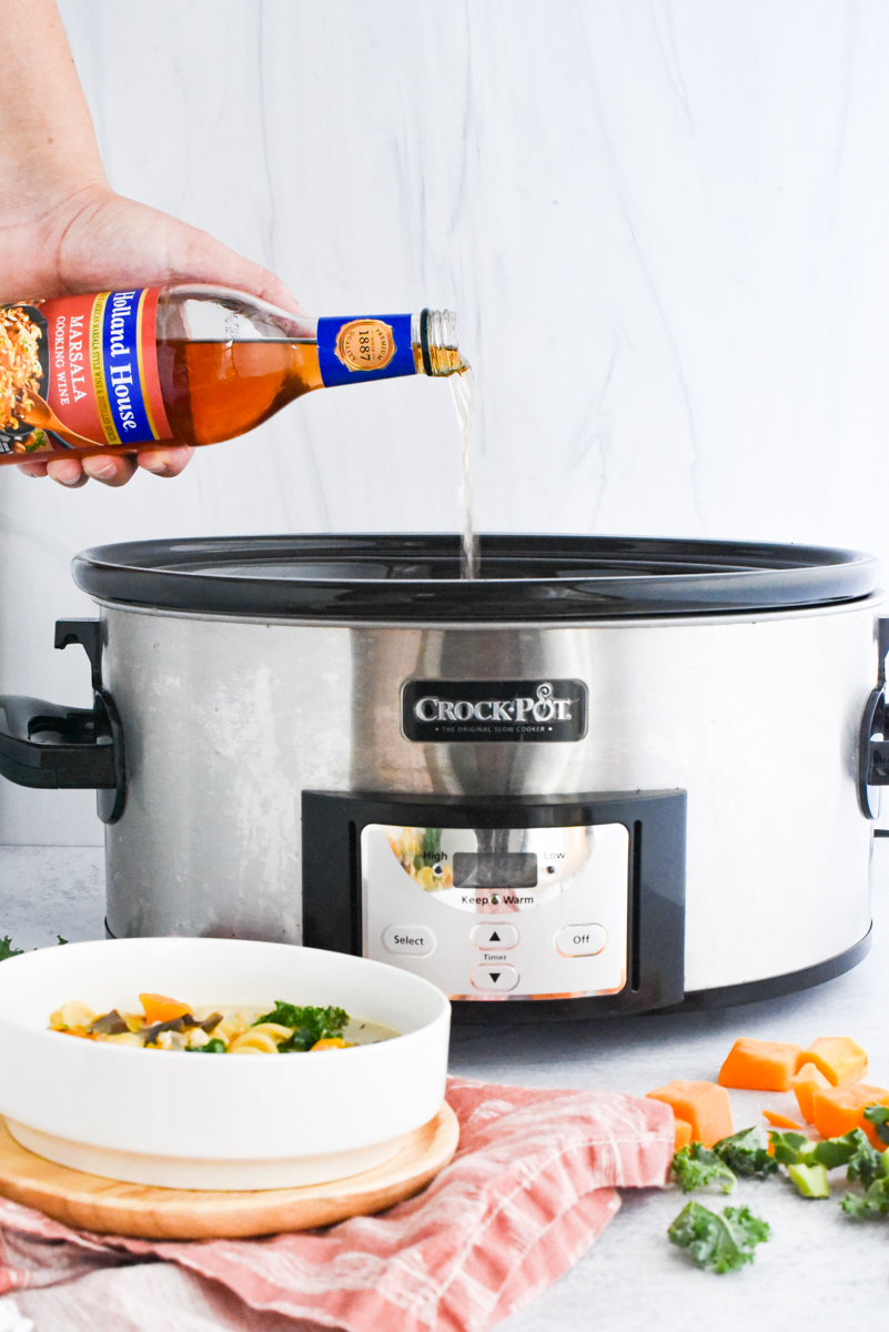 pouring cooking wine into crockpot