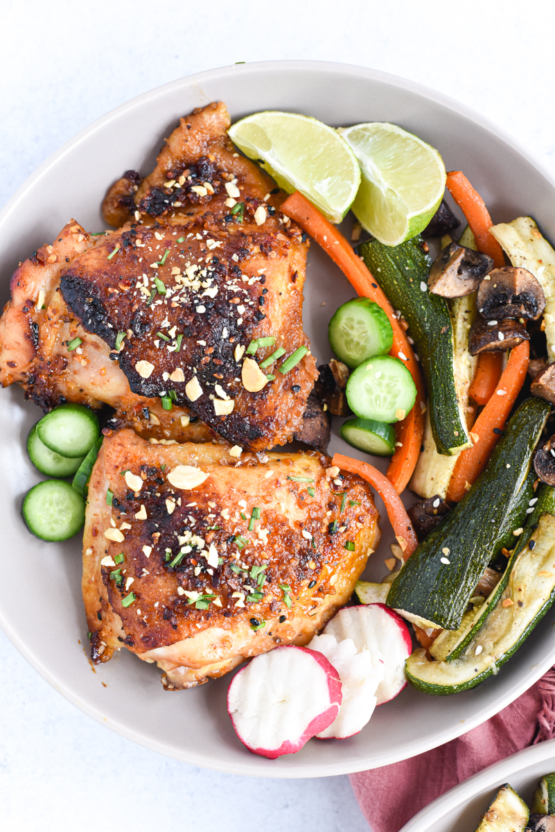 easy sheet pan peanut chicken on a plate with vegetables