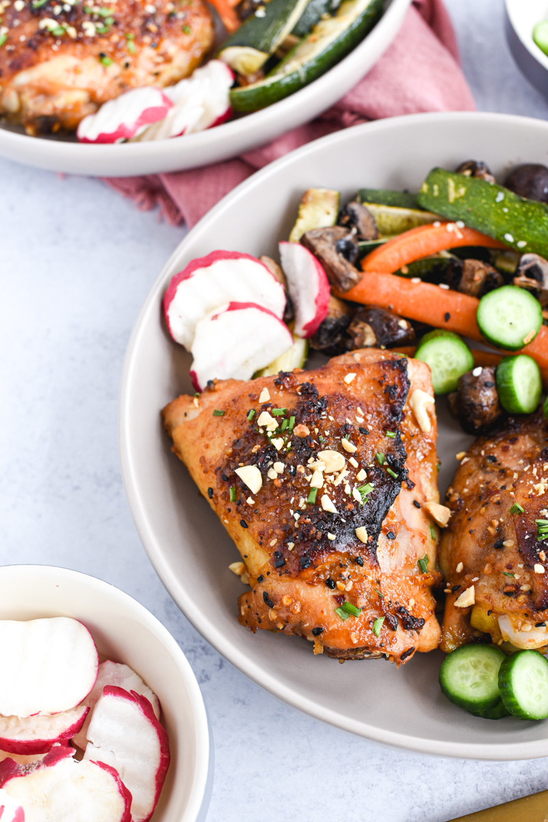 easy sheet pan peanut chicken on a plate with vegetables