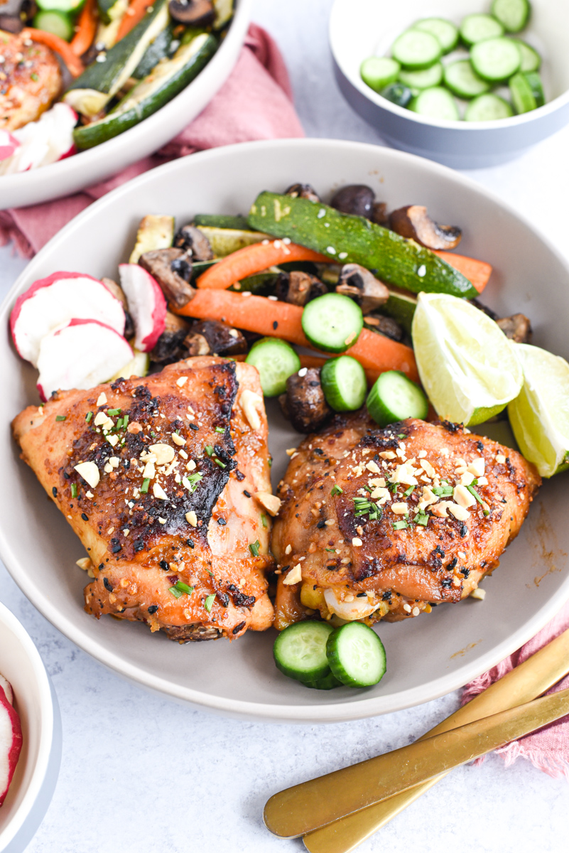 easy sheet pan peanut chicken on a plate with vegetables