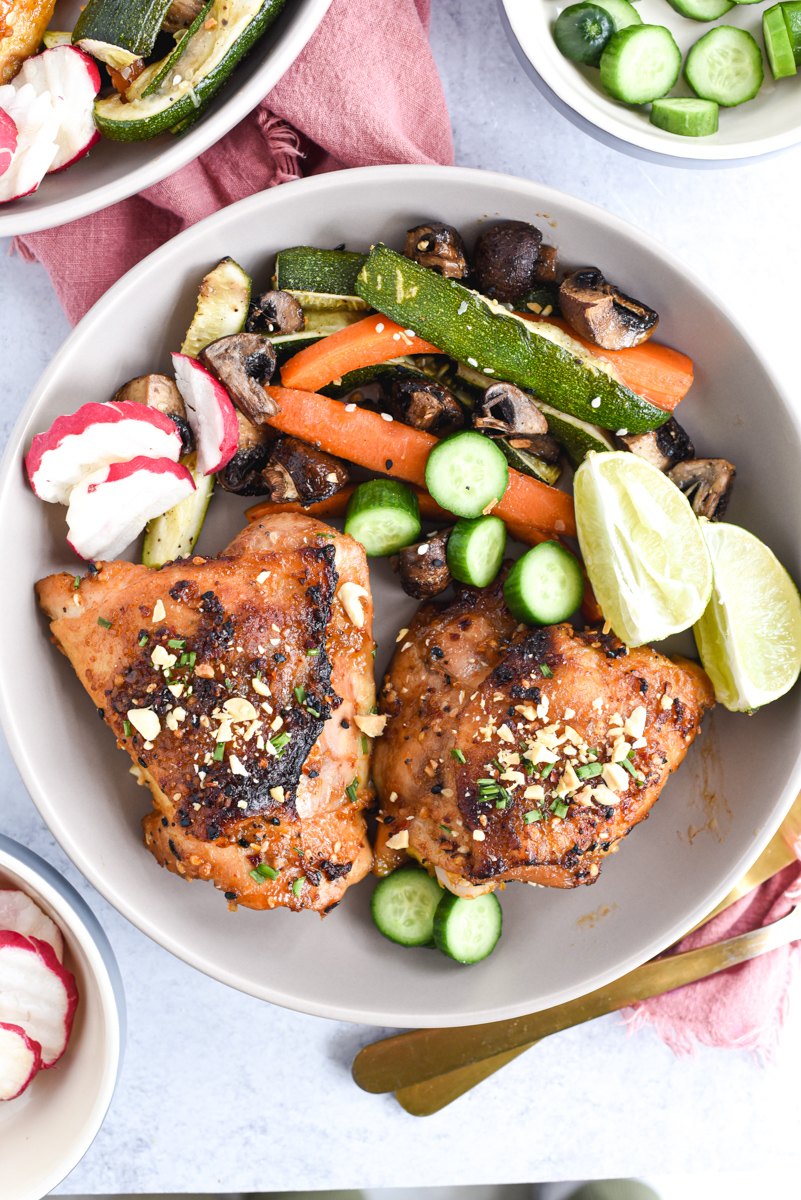 easy sheet pan peanut chicken on a plate with vegetables