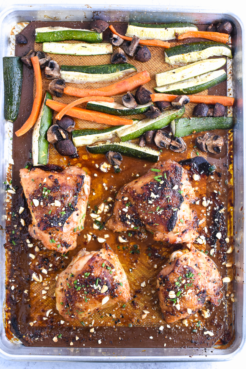 easy sheet pan peanut chicken on a plate with vegetables
